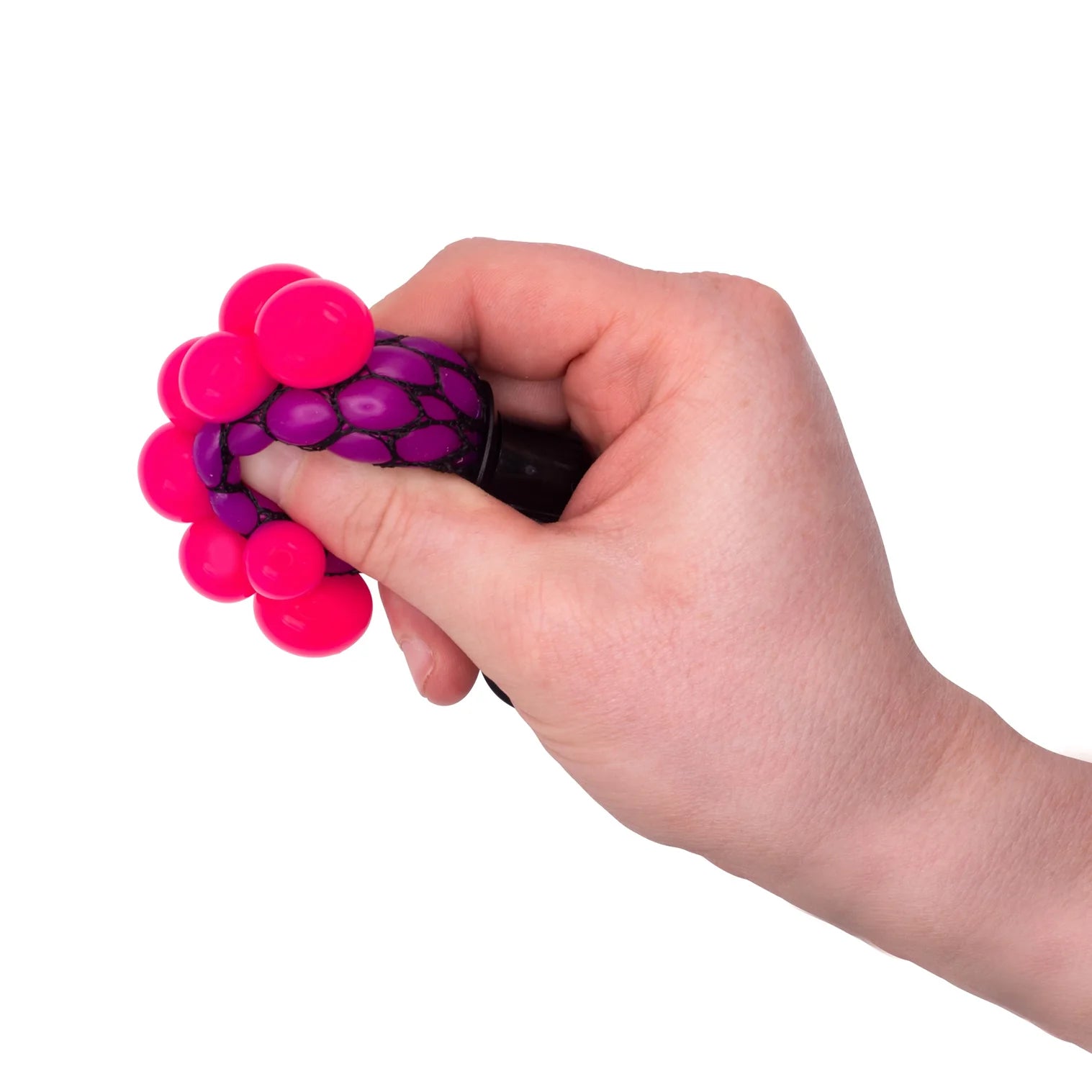 Hand holding a pink and purple stress ball against a white background