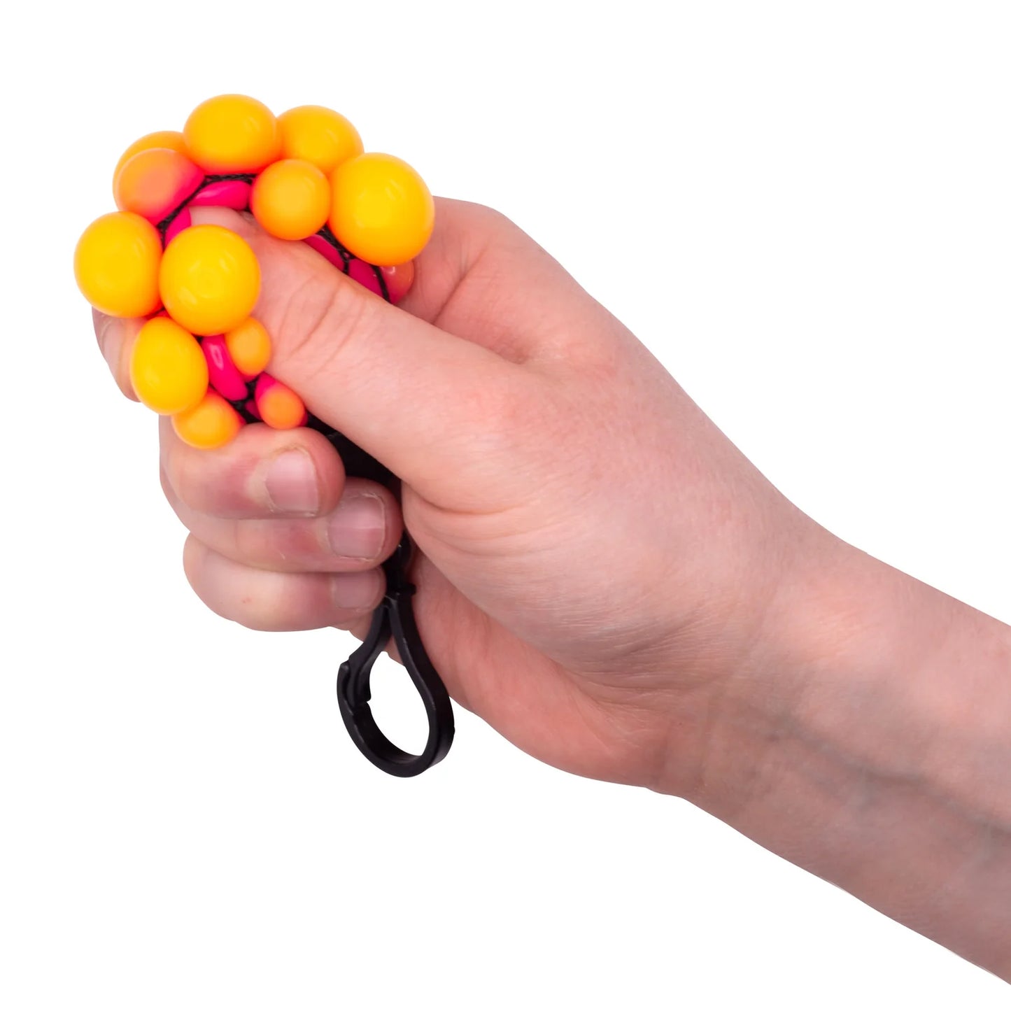 Hand holding a stress ball with yellow and pink beads on a white background