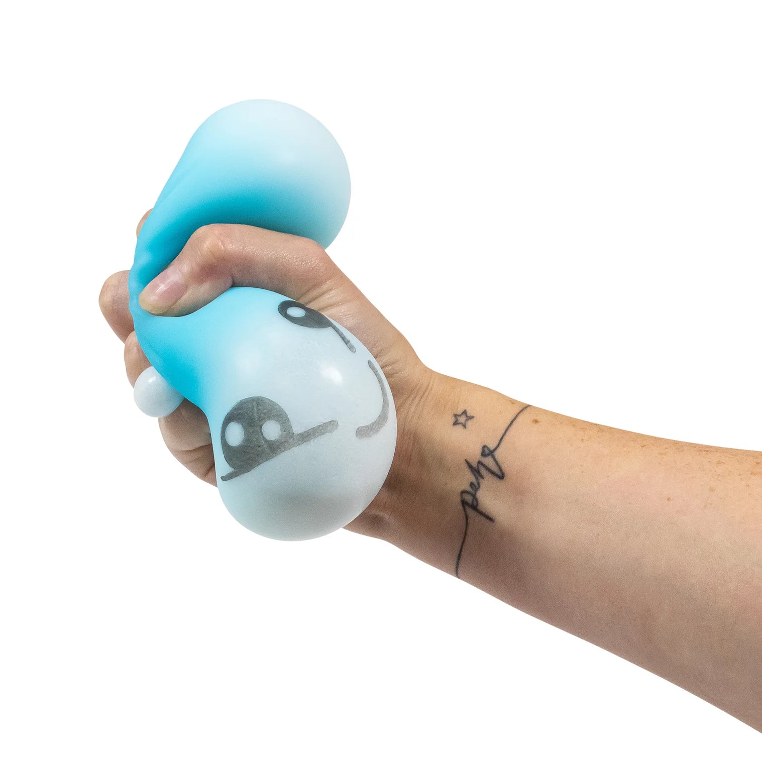 Hand holding a blue and white stress ball with a cartoon face on a white background