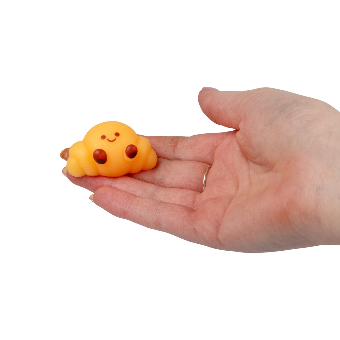 Small yellow cloud-shaped toy held in a hand on a white background