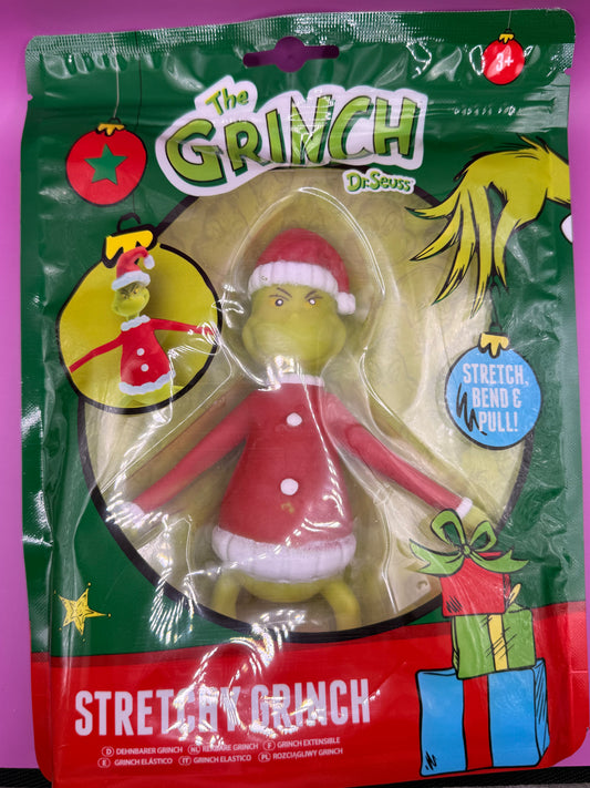 Packaged toy figure of a character from 'The Grinch' with festive design elements.