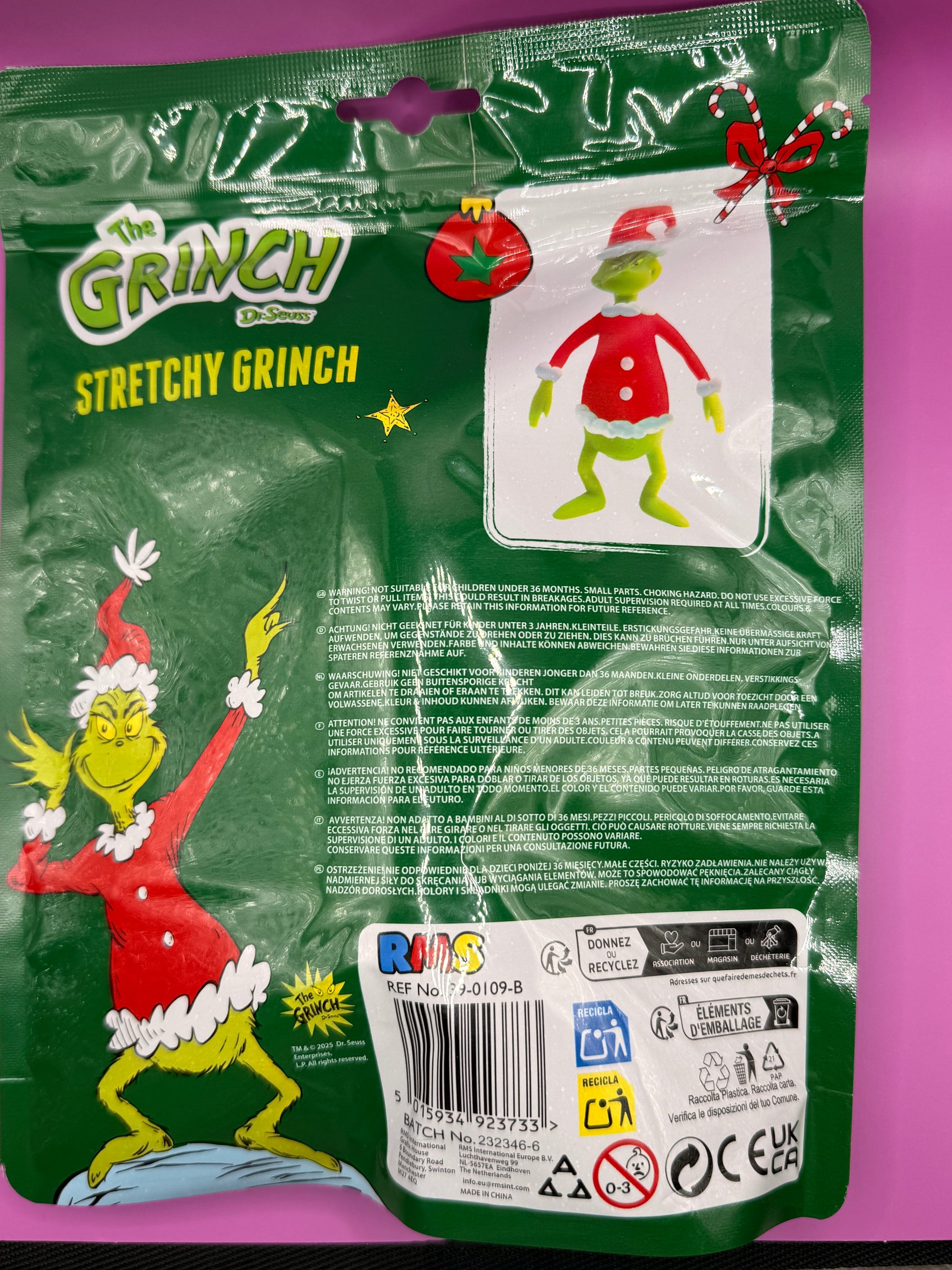 Packaging of Stretchy Grinch toy with green background and Grinch illustrations.