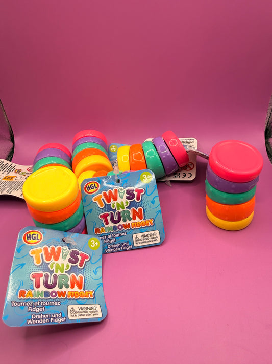 Colorful 'Twist 'n Turn' rainbow fidgets with packaging on a pink background